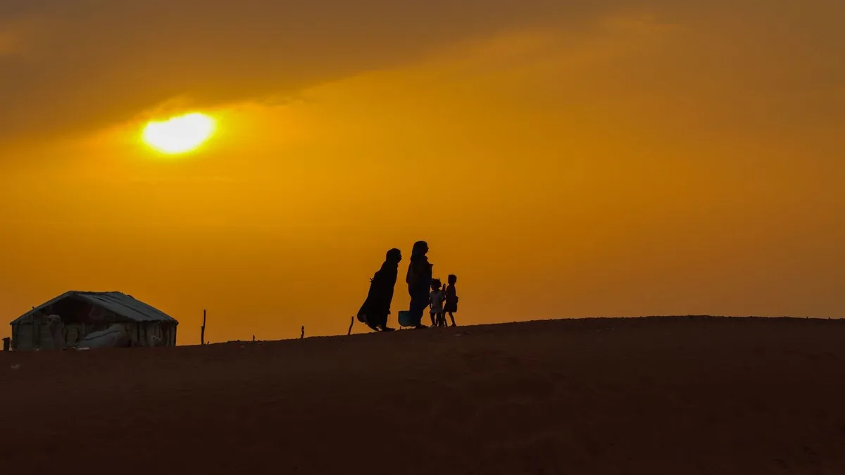 A family watching the desert sunset after moving to Nevada
