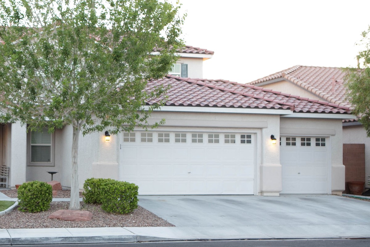 A concrete tile roof on a single story stucco tract home in the Las Vegas Valley, photographed from the street with desert landscaping in the foreground