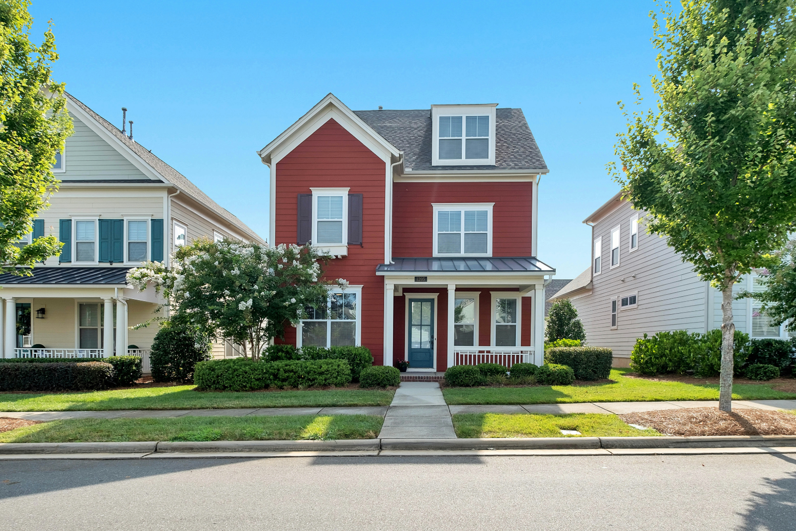 Las Vegas homeowner reviewing insurance cost and coverage options outside a two-story home